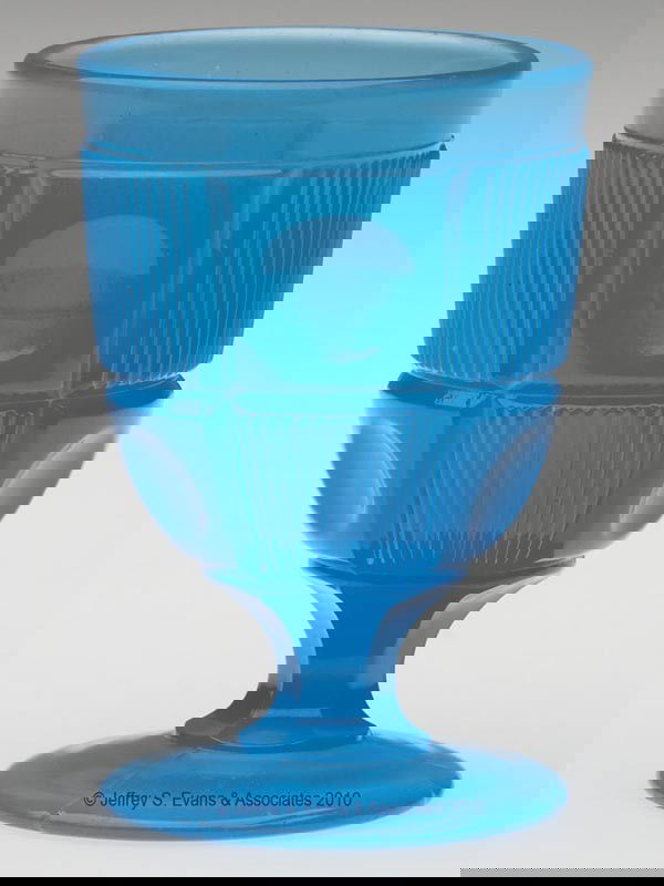 BULL'S EYE AND BAR EGG CUP / POMADE BASE: BULL'S EYE AND BAR EGG CUP / POMADE BASE, translucent starch blue. 3 3/4" h, 2 1/2" dia. Literature: Parallels B & K III, fig. 3267.Provenance: From the Collection of Mrs. Elizabeth R. Clatterbuck.