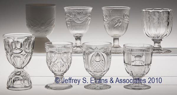 VARIOUS EAPG EGG CUPS, LOT OF SEVEN: VARIOUS EAPG EGG CUPS, LOT OF SEVEN, colorless flint, including Bull's Eye and Bar, and a double Excelsior, and five others. Together with a non-flint opaque white double Blackberry. Eight pieces tota