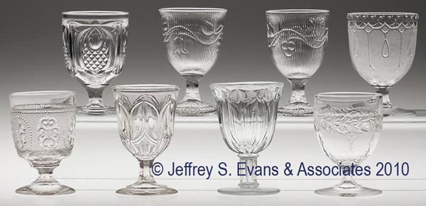 VARIOUS EAPG EGG CUPS, LOT OF EIGHT: VARIOUS EAPG EGG CUPS, LOT OF EIGHT, colorless flint, including two Bellflower and New England Pineapple, together with five others. 3 5/8" to 4" h. Provenance: From a Vermont collection.