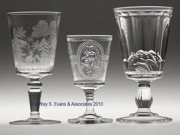 VARIOUS EAPG STEMS, LOT OF THREE: VARIOUS EAPG STEMS, LOT OF THREE, colorless, consisting of a Cupid & Venus champagne, and a New England Centennial and an etched Deer & Dog goblet. 5" to 6 5/8" h. Prov. CatNotes.: Provenance: From a 