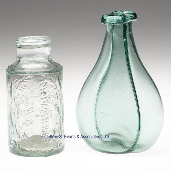TWO ASSORTED BLOWN AND MOLDED BOTTLES: TWO ASSORTED BLOWN AND MOLDED BOTTLES, comprising a pale green example embossed "N. W. / OPERMANN" and "MUSTARD / FACTORY" with a folded lip and rough pontil mark, along with a blue green gemel bottle