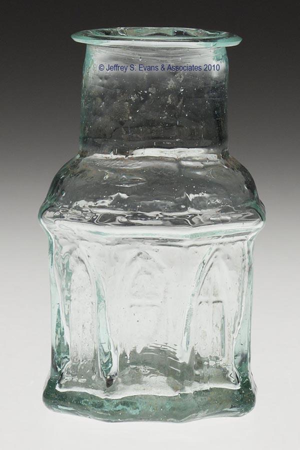 CATHEDRAL OCTAGONAL INK BOTTLE: CATHEDRAL OCTAGONAL INK BOTTLE, aqua, arched window molded on five sides, other three sides left plain for label, delicate flanged mouth, rough pontil mark. 1850-1870. 3 3/16" H, 1 7/8" DOA. Literatur
