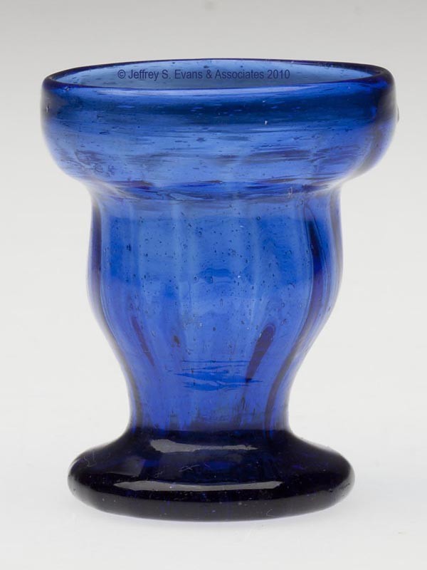 PATTERN-MOLDED RIB SALT OR EGG GLASS: PATTERN-MOLDED RIB SALT OR EGG GLASS, cobalt blue, double-ogee form bowl with 13 vertical ribs slightly swirled at the rim, raised on a drawn circular foot displaying a rough graphite pontil mark. Uni