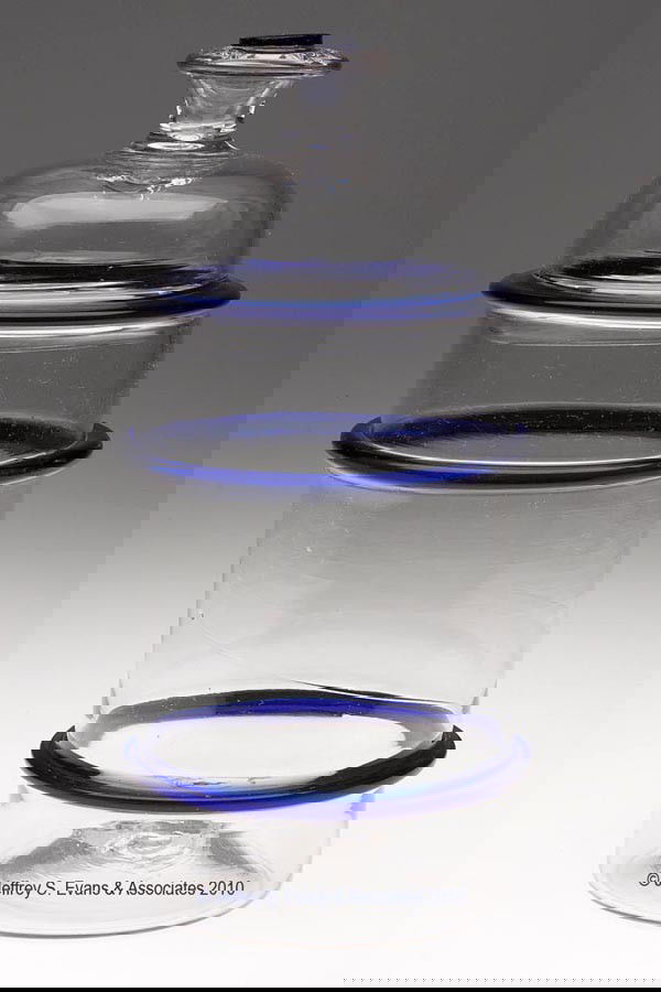 FREE-BLOWN RING JAR: FREE-BLOWN RING JAR, colorless and deep cobalt blue, cylindrical jar with two applied blue rings and a rough pontil mark, cover with an applied blue rim and button on top of the air-trap finial. Proba