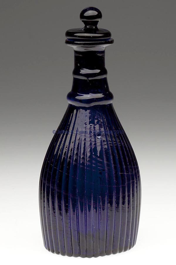 BLOWN-MOLDED GI-7 TYPE IV VARIANT CRUET OR TOILET B: BLOWN-MOLDED GI-7 TYPE IV VARIANT CRUET OR TOILET BOTTLE, deep cobalt blue, lacking neck ribs both between rings and above upper ring, plain lip, ribbed base with rough pontil mark, solid Tam-O'-Shant