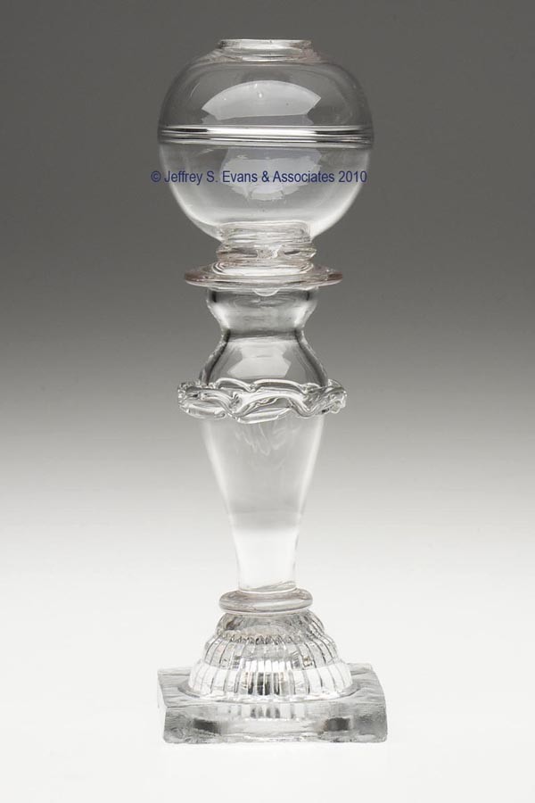 THOMAS CAINS DECORATED FREE-BLOWN AND PRESSED WHALE: THOMAS CAINS DECORATED FREE-BLOWN AND PRESSED WHALE OIL STAND LAMP, colorless, globular font with an interior horizontal-ring air trap, font applied by a wide bladed wafer to a hollow, elongated-pyrif