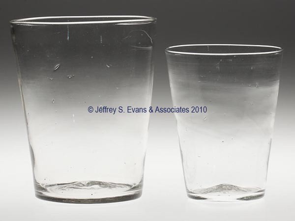 TWO FREE-BLOWN FLIP GLASSES: TWO FREE-BLOWN FLIP GLASSES, colorless, each of tapered form with a rough pontil mark. Probably United States. 19th century. 5 7/8" and 7 1/8" H. Provenance: From an Ohio private collection.
