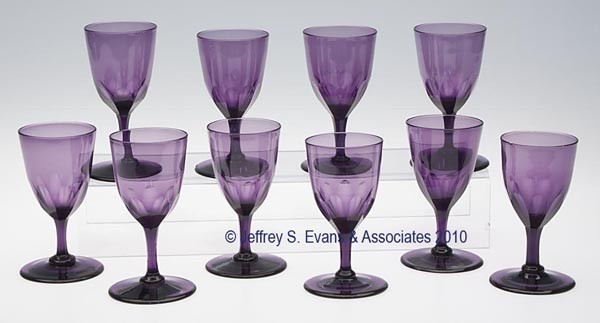 SET OF TEN FREE-BLOWN AND CUT CLARET GLASSES: SET OF TEN FREE-BLOWN AND CUT CLARET GLASSES, violet, each featuring a pointed round-funnel bowl raised on a drawn stem and applied circular foot with a polished pontil mark, each with eight cut flute