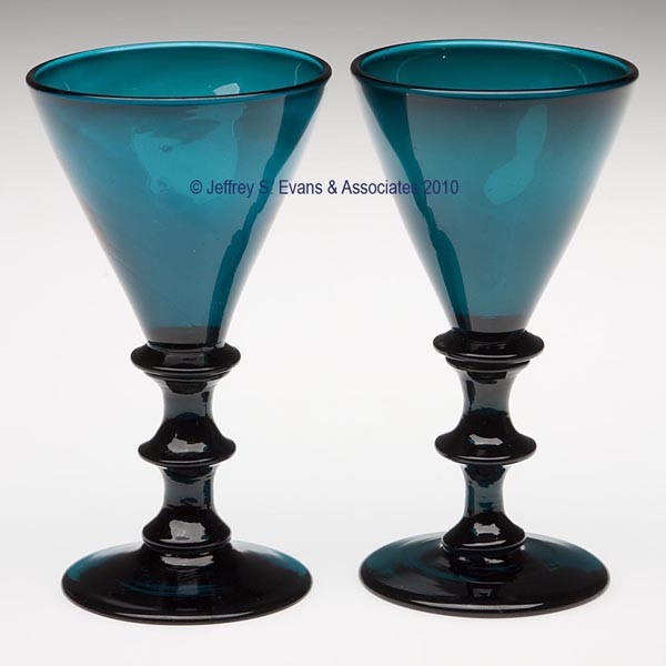 PAIR OF FREE-BLOWN WINE GLASSES: PAIR OF FREE-BLOWN WINE GLASSES, brilliant teal, each featuring a conical bowl raised on an applied knopped stem and circular foot with a rough pontil mark. England. 19th century. 5" H.