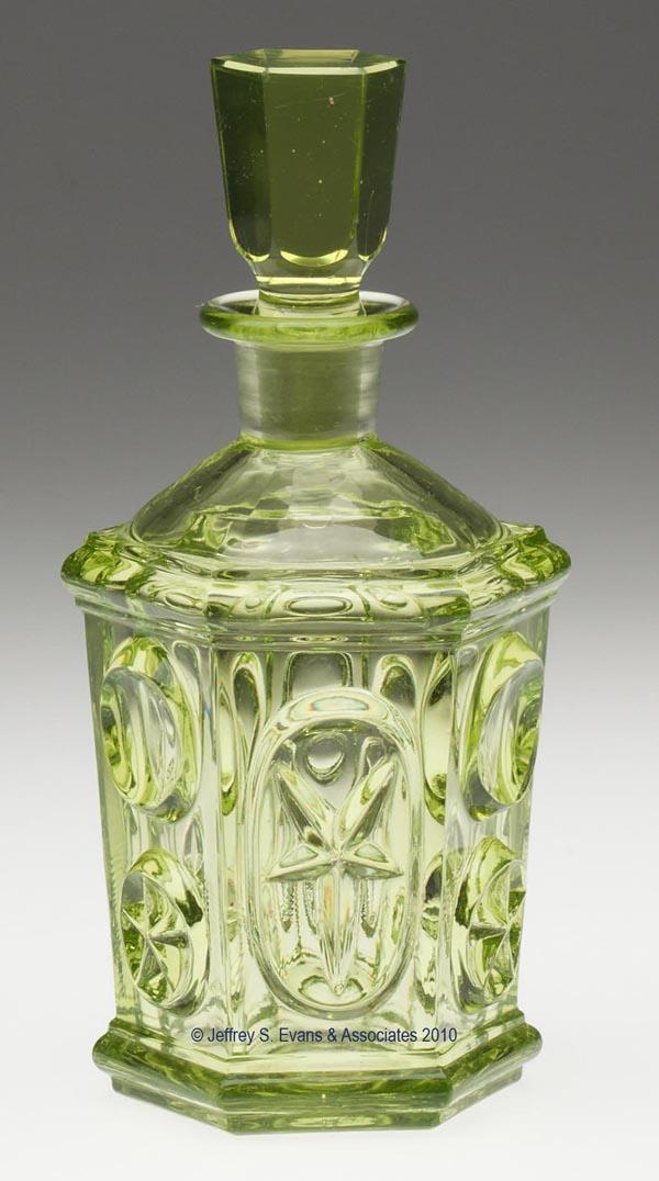 PRESSED STAR AND PUNTY COLOGNE BOTTLE: PRESSED STAR AND PUNTY COLOGNE BOTTLE, strong yellow green/vaseline, large-size hexagonal form produced from the same mold as the spooner and stand lamp large font, polished pontil mark, original pane