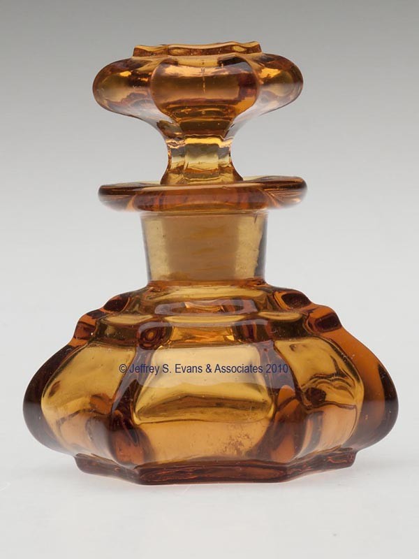 BLOWN-MOLDED HEXAGONAL DIMINUTIVE COLOGNE BOTTLE: BLOWN-MOLDED HEXAGONAL DIMINUTIVE COLOGNE BOTTLE, honey amber, squat form with a two-step shoulder, flanged mouth, and a wide polished pontil mark, original hexagonal solid stopper. Neither unit numbe