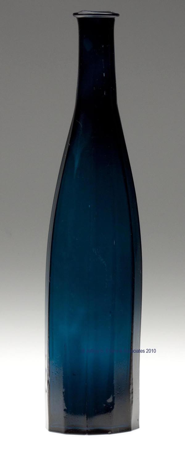 BLOWN-MOLDED PANELED COMMERCIAL COLOGNE BOTTLE: BLOWN-MOLDED PANELED COMMERCIAL COLOGNE BOTTLE, deep brilliant teal, tall tapered form with 12 panels, wide tooled lip, and a plain base. Boston & Sandwich Glass Co. and others. 1850-1870. 11" H, 2 1/
