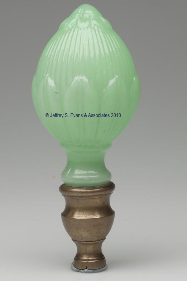 BLOWN-MOLDED PETAL AND RIB FINIAL: BLOWN-MOLDED PETAL AND RIB FINIAL, slightly translucent jade green, egg-shape with lower extension plastered into a brass mount with lower threaded receiver, probably for a newel post. Boston & Sandwi