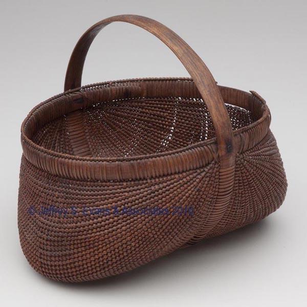 SHELTON SISTERS, FORSYTH CO., NC ATTRIBUTED RIB-TYP: SHELTON SISTERS, FORSYTH CO., NC ATTRIBUTED RIB-TYPE BASKET extremely finely woven kidney form with delicate wrapped rim and arched handle. Varnished surface. 1890-1920. 5 3/4" HOA, 3 1/2" H rim, 6" D