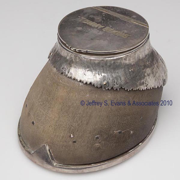 ROWLAND WARD SILVER-PLATE-MOUNTED HORSE HOOF INKWE: ROWLAND WARD SILVER-PLATE-MOUNTED HORSE HOOF INKWELL engraved "Tommy Atkins" on the hinged lid, marked for Rowland Ward Limited under the shoe, original well insert. Second quarter 20th century. 3" H,