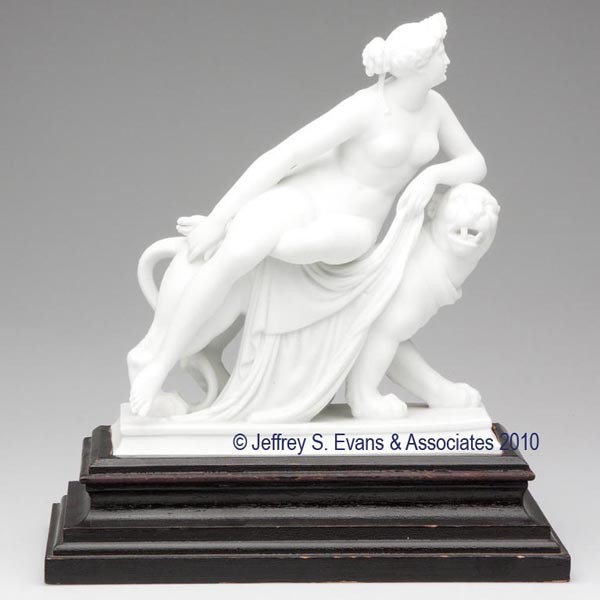 ARIADNE WITH PANTHER PARIAN FIGURAL GROUP: ARIADNE WITH PANTHER PARIAN FIGURAL GROUP nude wearing a vine leaf headdress, reclining on the back of a collared panther with a large cloak draped over its back, raised on a rectangular plinth base, 