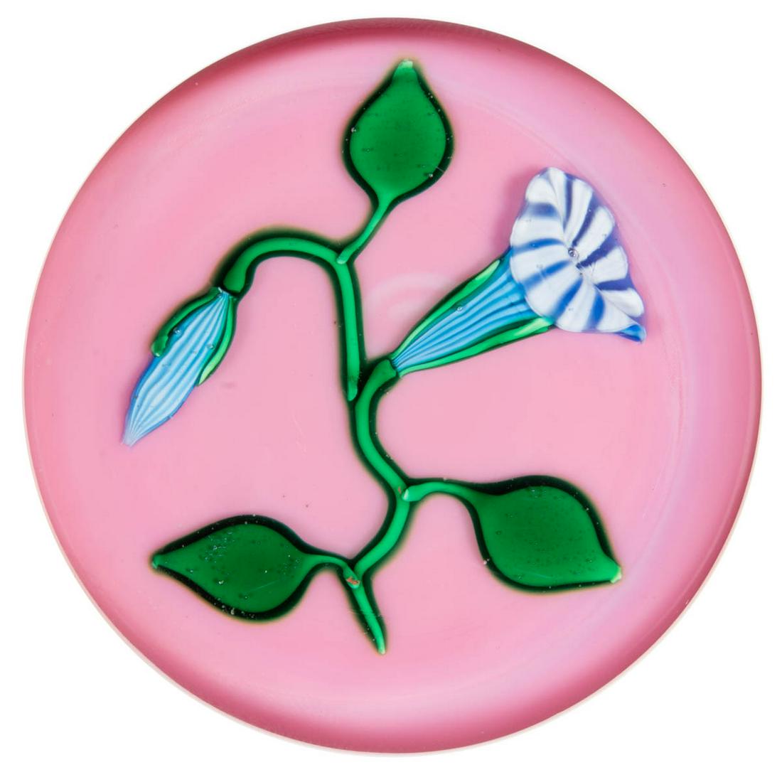 CHARLES KAZIUN JR. (AMERICAN, 1919-1992) MORNING GLORY: CHARLES KAZIUN JR. (AMERICAN, 1919-1992) MORNING GLORY LAMPWORK STUDIO ART GLASS PAPERWEIGHT, single blue and white morning glory blossom, connected to a curling green stem supporting three green leav