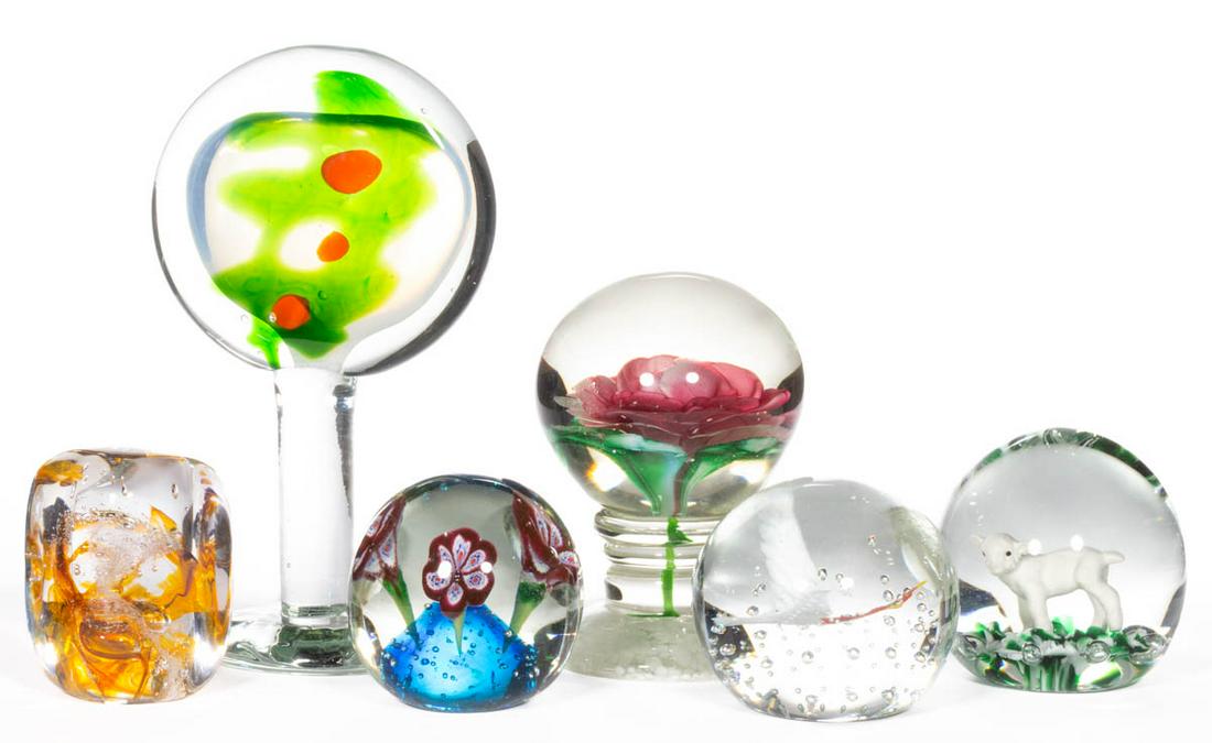 ASSORTED GLASS PAPERWEIGHTS, LOT OF SIX: ASSORTED GLASS PAPERWEIGHTS, LOT OF SIX, including a lampwork rose pedestal paperweight, an abstract pedestal paperweight, and a Gibson sulphide lamb example. Various makers. 20th century. 3" to 8" HO