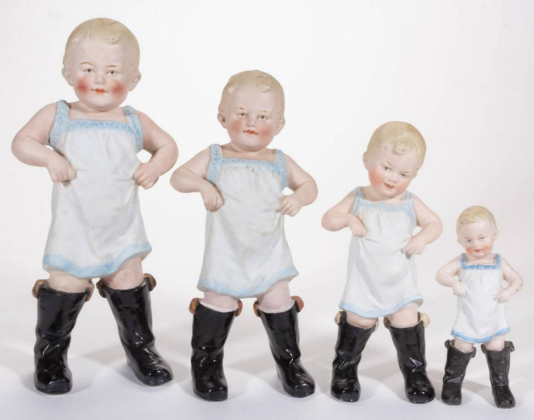 GERMAN GEBRUDER HEUBACH BISQUE PORCELAIN BOY GRADUATED: GERMAN GEBRUDER HEUBACH BISQUE PORCELAIN BOY GRADUATED FIGURES, LOT OF FOUR, each having polychrome hand-painted decorations and featuring a child standing in men's black boots. Marks include one havi