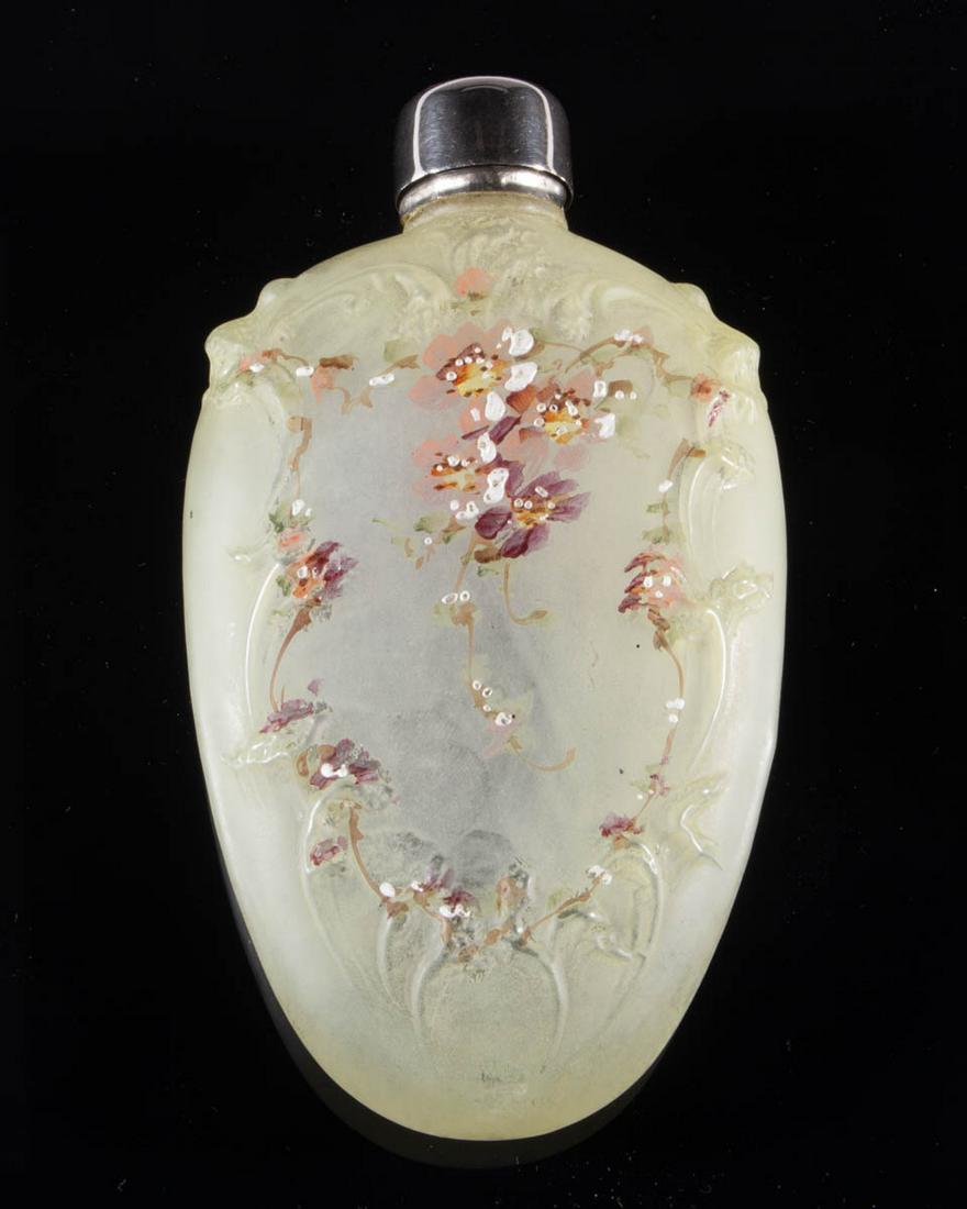 WAVE CREST ENAMEL-DECORATED ART GLASS WHISKEY FLASK: WAVE CREST ENAMEL-DECORATED ART GLASS WHISKEY FLASK, frosted colorless with polychrome-enamel decoration, embossed scrolling to the surface with floral decoration, original collar and lid. C. F. Monro