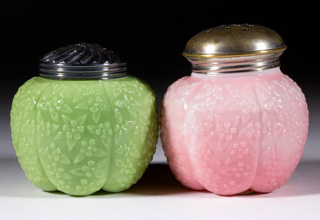CHALLINOR FORGET-ME-NOT SUGAR SHAKERS, LOT OF TWO: CHALLINOR FORGET-ME-NOT SUGAR SHAKERS, LOT OF TWO, opaque pink and opaque green, each having a period lid. Challinor, Taylor & Co. Pattern introduced in 1885. 3 3/4" and 4" H.Provenance: From a Shenan