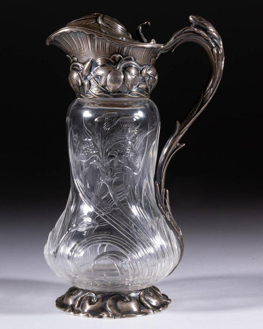 HAWKES ATTRIBUTED INTAGLIO CUT GLASS SYRUP PITCHER: HAWKES ATTRIBUTED INTAGLIO CUT GLASS SYRUP PITCHER, colorless, baluster-form body with iris cut pattern with long flowing blades of grass, having two flower blossoms and two buds, fitted with the orig