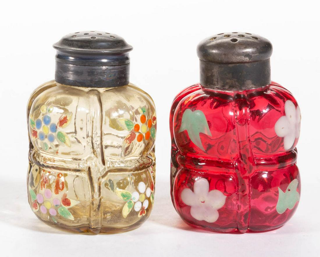 PAIRPOINT BALE ENAMEL-DECORATED SALT AND PEPPER: PAIRPOINT BALE ENAMEL-DECORATED SALT AND PEPPER SHAKERS, LOT OF TWO, amber and cranberry with polychrome-enamel decoration, each having floral decoration and a period two-part lid. Late 19th/early 20t