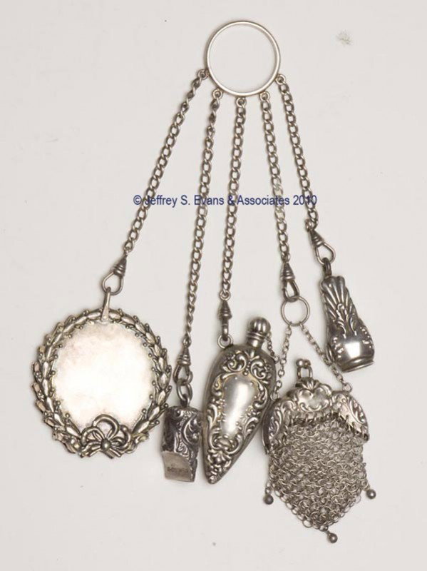 STERLING SILVER DANCE FINGER RING CHATELAINE: STERLING SILVER DANCE FINGER RING CHATELAINE, ring suspending five chains and near-matching appendages with scroll and floral patterns. Appendages consist of a mesh purse with an additional hook; a wr