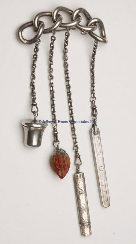 METAL AND STERLING SILVER NEEDLEWORKING BROOCH CHAT: METAL AND STERLING SILVER NEEDLEWORKING BROOCH CHATELAINE, metal chain-form brooch suspending five chains and four sterling silver appendages. Appendages consist of a thimble case with unidentified ma