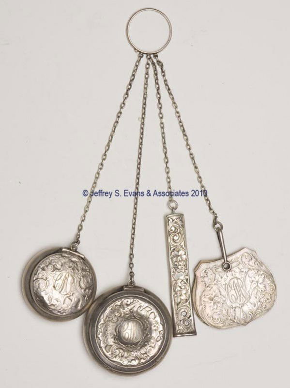 WEBSTER STERLING SILVER FINGER RING CHATELAINE: WEBSTER STERLING SILVER FINGER RING CHATELAINE, ring suspending four chains and four matching floral embossed appendages consisting of a coin dispenser, a compact with mirror, a needle case, and a mem