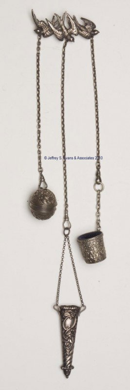STERLING SILVER FIGURAL NEEDLEWORKING CHATELAINE: STERLING SILVER FIGURAL NEEDLEWORKING CHATELAINE, brooch pin attached to three birds, suspending three chains and three non-matching patterned appendages consisting of a Foster and Bailey spool holder