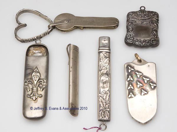 STERLING SILVER CHATELAINE APPENDAGES, LOT OF SIX: STERLING SILVER CHATELAINE APPENDAGES, LOT OF SIX, consisting of three open-top needle cases, one example with applied insects and another with applied fleur-de-lis; an English needle case with emboss