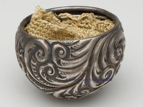 S. COTTLE CO. STERLING SILVER CHATELAINE PURSE: S. COTTLE CO. STERLING SILVER CHATELAINE PURSE, ball form with overall heavily embossed scroll pattern, interior fitted with a tan crocheted liner and detached drawstring, includes two matching slides