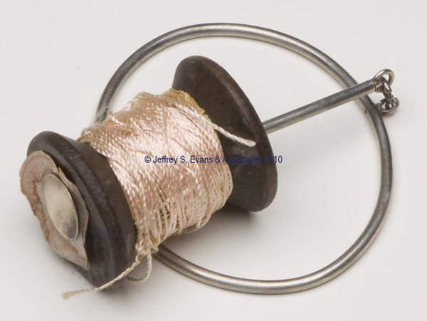 STERLING SILVER WRIST SPOOL KNAVE: STERLING SILVER WRIST SPOOL KNAVE, unpatterned, marked Sterling on end of spool holder. Late 19th/early 20th century. 6 1/4" h overall. Provenance: Collection of the late Hilda Fried of New York City.