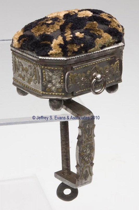 STEEL WITH TULA WORK SEWING CLAMP WITH DRAWER AND P: STEEL WITH TULA WORK SEWING CLAMP WITH DRAWER AND PIN CUSHION, octagonal form with four bun feet, applied brass and metal floral garland and bead embellishments, attached to a c-clamp with matching de