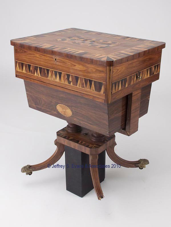 REGENCY TUNBRIDGEWARE ROSEWOOD VENEER SEWING WORK : REGENCY TUNBRIDGEWARE ROSEWOOD VENEER SEWING WORK AND WRITING TABLE, four downswept legs with scroll-embossed brass foot caps and casters, supporting a platform, two short turned pedestals, and a rect