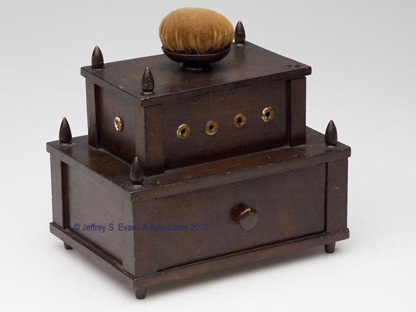 WALNUT ONE-DRAWER SEWING WORK BOX WITH THREAD DISP: WALNUT ONE-DRAWER SEWING WORK BOX WITH THREAD DISPENSERS, two tier, each corner having a finial, brown velvet covered pin cushion top which lifts off to reveal seven metal spool reels, ends and front 