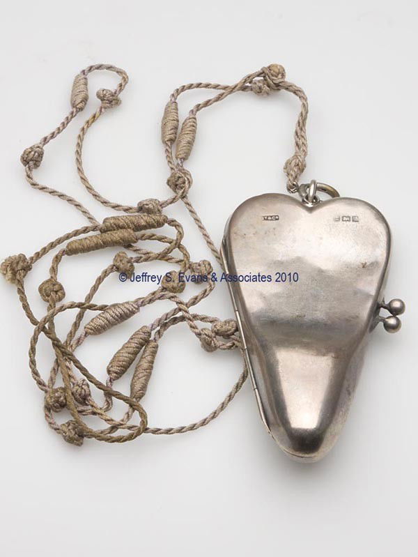 ENGLISH SILVER FIGURAL SEWING KIT: ENGLISH SILVER FIGURAL SEWING KIT, heart form, purse clasp hinges open to reveal a leather lining containing a pair of German "Louise" scissors and a Simon's sterling silver thimble, chatelaine hook w