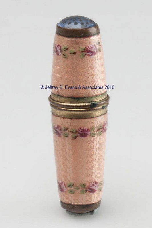 ENAMEL ON BRASS SEWING KIT: ENAMEL ON BRASS SEWING KIT, bullet form, pink guilloche' with floral bands, threaded thimble end with pale blue stone top, interior fitted with a four-reel thread holder and a folding pair of scissors
