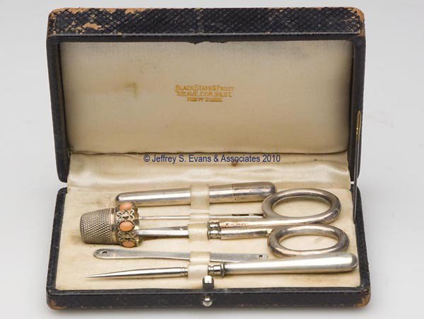 BLACK, STARR & FROST SEWING KIT: BLACK, STARR & FROST SEWING KIT, black leather covered box with hinged lid, interior of lid with cream colored lining and a gilt silk maker's stamp, bottom with matching colored velvet lining with fiv