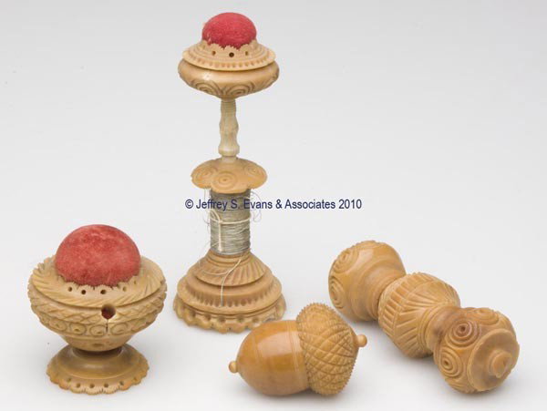 CARVED VEGETABLE IVORY SEWING ARTICLES, LOT OF FOU: CARVED VEGETABLE IVORY SEWING ARTICLES, LOT OF FOUR, consisting of two pin cushions with original red velvet fabric, including a combination with spool reel, possibly together by association; a needle