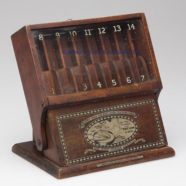 BOYE NEEDLE COMPANY WOODEN COUNTER-TOP DISPLAY CAS: BOYE NEEDLE COMPANY WOODEN COUNTER-TOP DISPLAY CASE, slanted form, fitted with 14 compartments, each with stenciled size for crochet needles, glass fold-out front with clasp and stenciled size over or