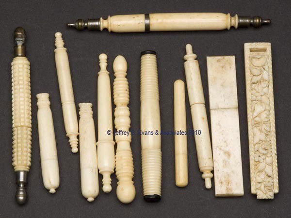 CARVED BONE / IVORY NEEDLE CASES, LOT OF 12: CARVED BONE / IVORY NEEDLE CASES, LOT OF 12, ten cylindrical forms and two rectangular forms with slide top, one example with heavy carved fruit and floral pattern. Third quarter 19th century. 2" to 4