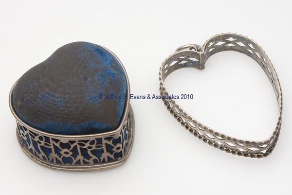 STERLING SILVER PIN CUSHIONS, LOT OF TWO: STERLING SILVER PIN CUSHIONS, LOT OF TWO, consisting of a Gorham example with floral cut-out pattern, blue velvet pin cushion which lifts off to reveal a compartment, maker's mark; and an example with