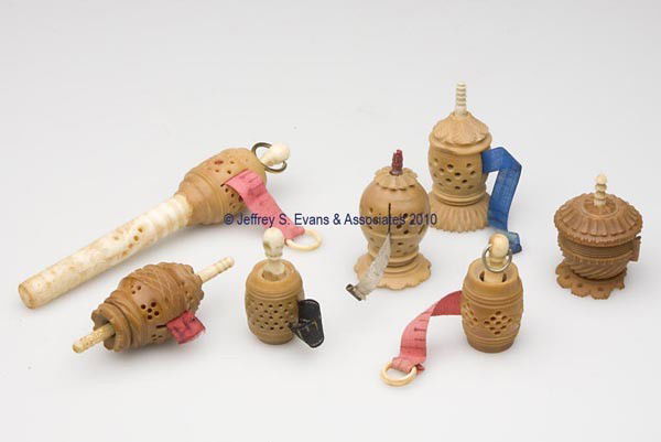 CARVED VEGETABLE IVORY TAPE MEASURES, LOT OF SEVEN: CARVED VEGETABLE IVORY TAPE MEASURES, LOT OF SEVEN, various barrel and footed forms, including one example with a bone/ivory needle case, each with a bone/ivory winder, fabric tapes calibrated in inch