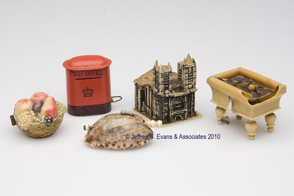 CELLULOID / PLASTIC FIGURAL TAPE MEASURES, LOT OF : CELLULOID / PLASTIC FIGURAL TAPE MEASURES, LOT OF FIVE, consisting of a basket of fruit, castle, pool table, post office, and a shell, each in working condition and with various tape calibrations. Lat