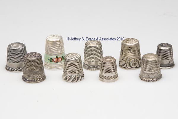 VARIOUS STERLING SILVER THIMBLES, LOT OF NINE: VARIOUS STERLING SILVER THIMBLES, LOT OF NINE, consisting of three Ketcham & McDougall examples including a Chased Rope Band, Lily-of-the-Valley, and a Damask Lily; two Henry Muhr & Sons examples; a F