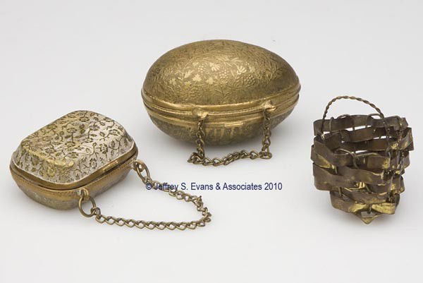 METAL WITH BRASS FINISH FIGURAL THIMBLE CASES , LO: METAL WITH BRASS FINISH FIGURAL THIMBLE CASES , LOT OF THREE, two examples with a hinged cover and overall stamped floral pattern and chains, consisting of an egg-form example and a purse form with re