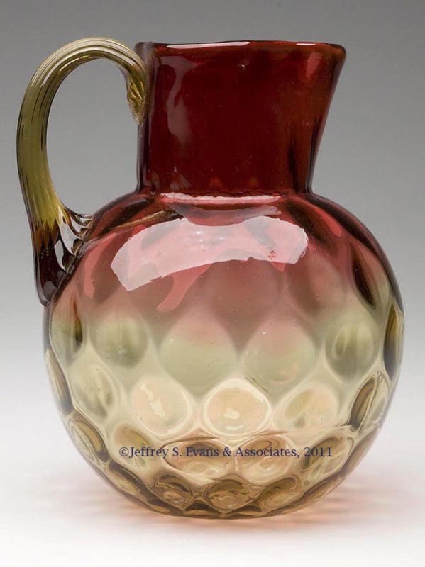 PHOENIX AMBERINA INVERTED THUMBPRINT WATER PITCHER: PHOENIX AMBERINA INVERTED THUMBPRINT WATER PITCHER, triangular rim, amber applied reeded handle, polished pontil mark. Phoenix Art Glass. Fourth quarter 19th century. 7 1/2" HOA, 6" DOA. Provenance: C