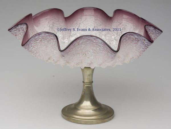 CASED ART GLASS COMPOTE: CASED ART GLASS COMPOTE, amethyst shaded to clear, crackled layer on exterior, tooled rim, fitted on a silver-plate standard. Continental. First half 20th century. 7 1/8" H, 11 1/4" DOA.